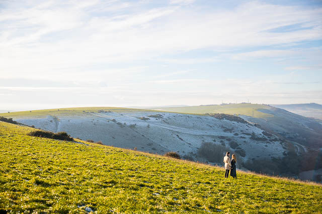Engaged couple embracing at Devil's Dyke, Sussex