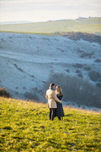 Couple embracing each other with Devil's Dyke as the backdrop