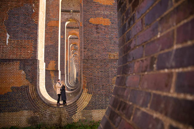 Bride and groom standing at the Sussex Ouse Valley Viaduct