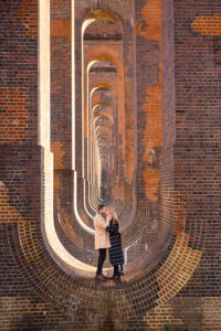 Bride and groom standing at the Sussex Ouse Valley Viaduct