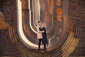 Bride and groom standing at the Ouse Valley Viaduct