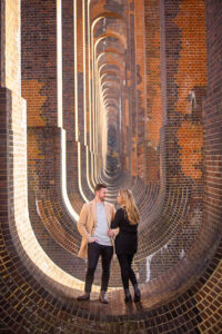 Bride and groom standing at the Ouse Valley Viaduct