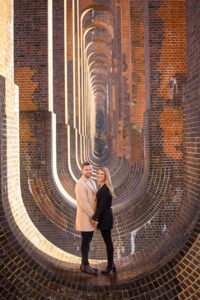 Couple standing on top of the Sussex Ouse Valley Viaduct