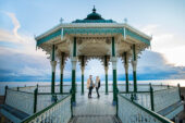 Engaged couple posing at the Brighton Beach Bandstand.