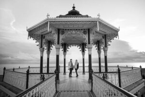 Engaged couple posing at the Brighton Beach Bandstand.