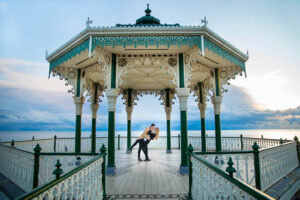 Couple twirling at the Brighton Bandstand on the Brighton Beach seafront.
