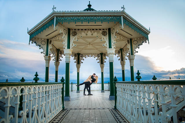 Couple twirling at the Brighton Bandstand on the Brighton Beach seafront. 