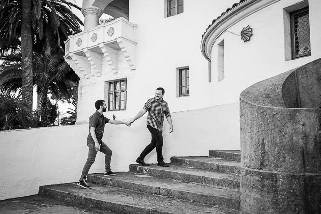 Engaged couple walking around the Santa Barbara Courthouse