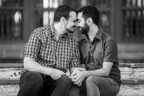 Gay couple embracing at the Fiesta Stage steps at the Santa Barbara Courthouse