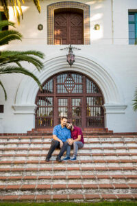 Gay couple embracing at the Fiesta Stage steps at the Santa Barbara Courthouse
