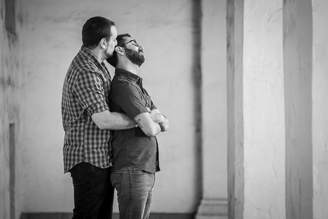 LGBTQ couple embracing at their Santa Barbara Courthouse engagement photo session.