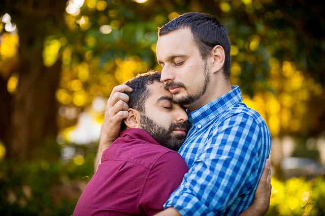 Romantic close-up of gay couple embracing at their Santa Barbara Courthouse engagement photo session.
