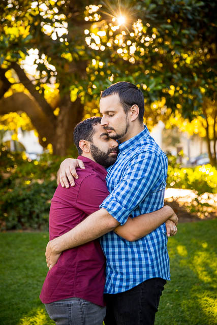 Romantic close-up of gay couple embracing at their Santa Barbara Courthouse engagement photo session.